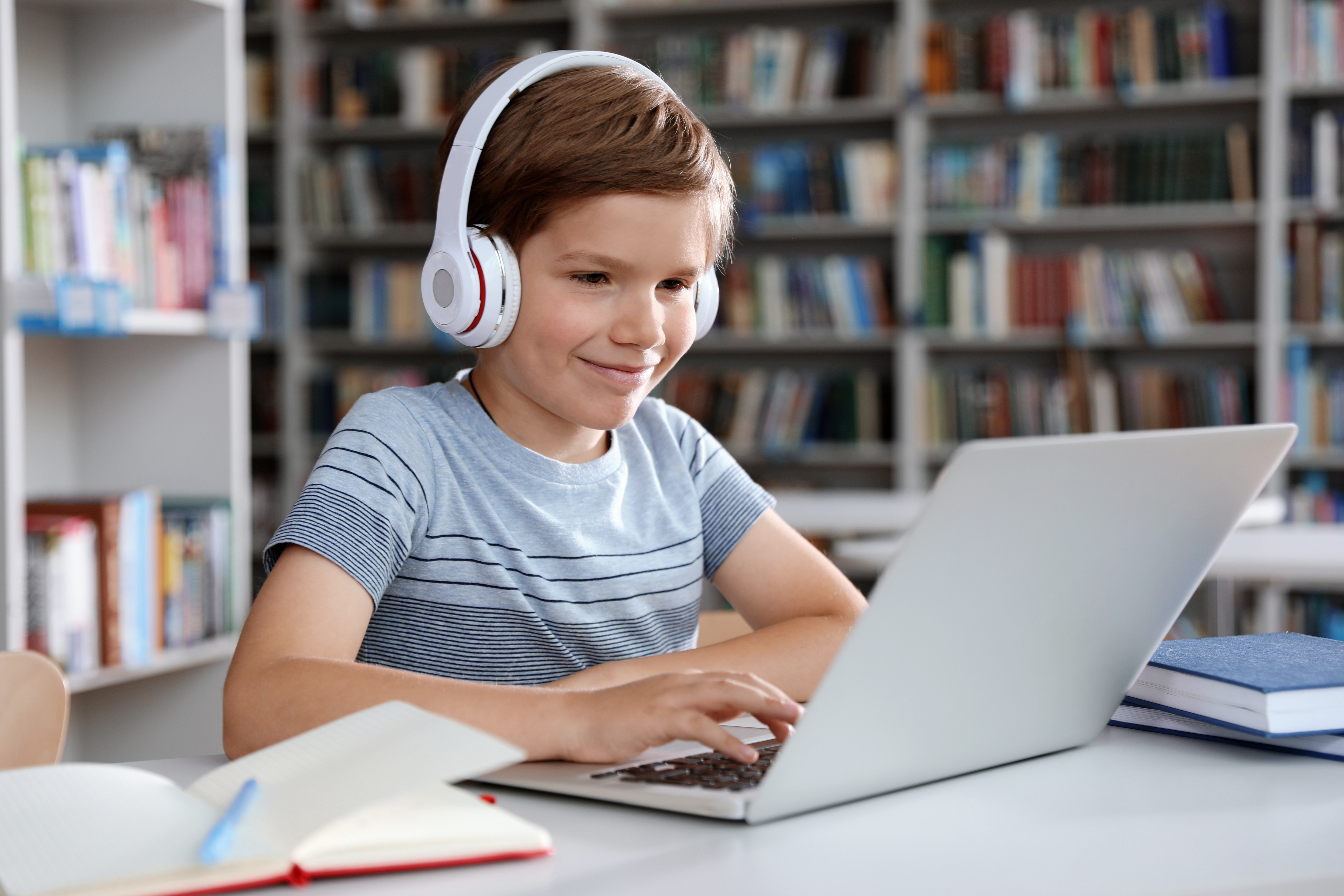 Child completing online learning on a laptop